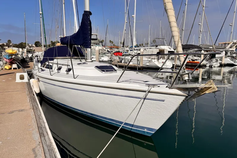 2001 Catalina 36 MkII sailboat docked in a marina, surrounded by other boats.