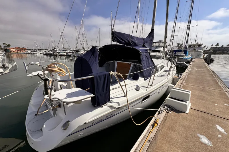 Catalina 36 MkII 2001 sailboat docked at marina under cloudy sky.