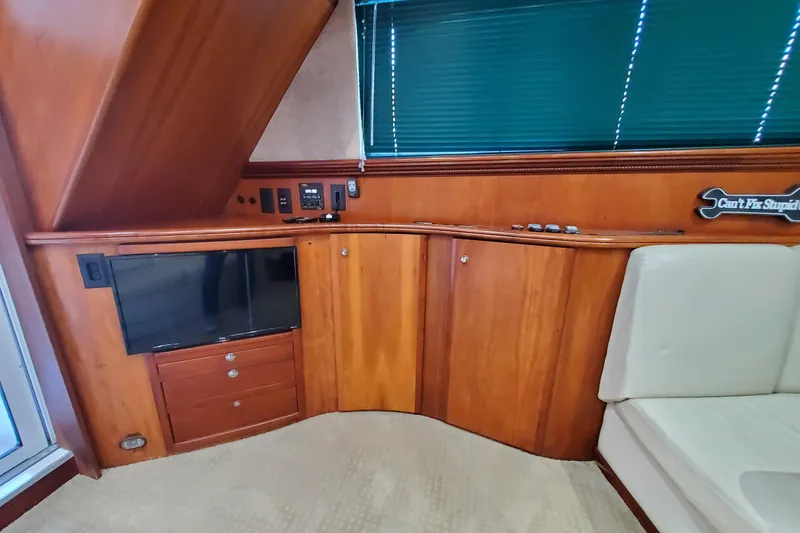 Interior of 2000 Silverton 42 Convertible yacht with wood cabinetry and TV.