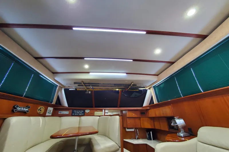 Interior of a 2000 Silverton 42 Convertible yacht with seating and wooden cabinetry.