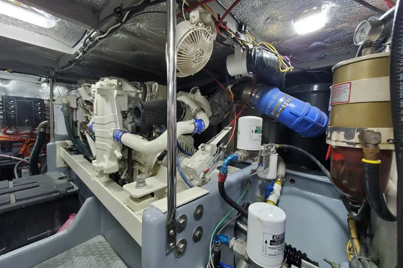 Engine room of a 2000 Silverton 42 Convertible yacht, showcasing mechanical components.