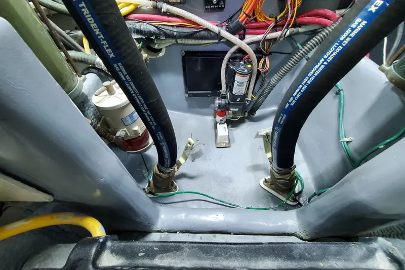Engine compartment of a 2000 Silverton 42 Convertible boat with hoses and wiring.