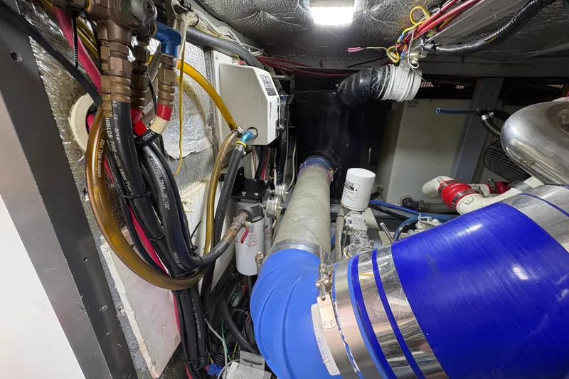 Engine room of a 2000 Silverton 42 Convertible with visible hoses and wiring.
