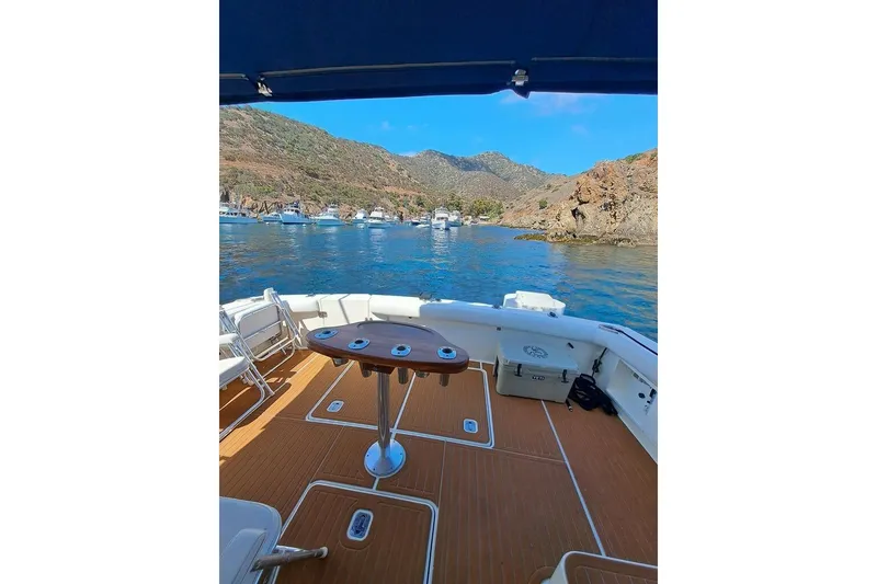 2000 Silverton 42 Convertible yacht with scenic coastal view and clear blue waters.