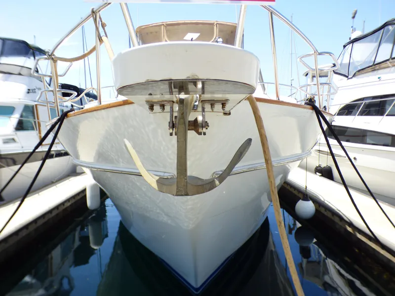 Front view of 1987 MedYacht Mallorca 50 docked, showcasing anchor and sleek design.