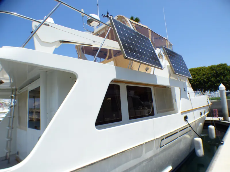 1987 MedYacht Mallorca 50 with solar panels docked at marina.