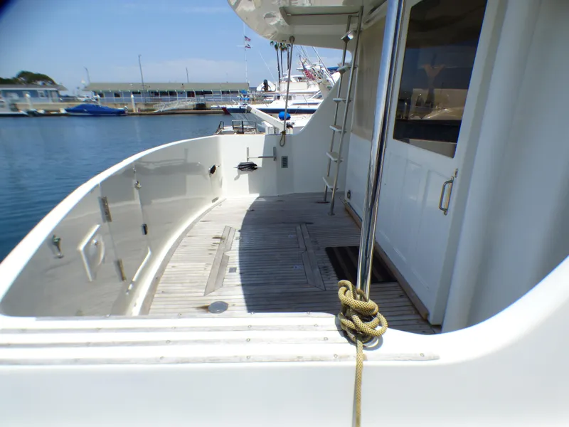 1987 MedYacht Mallorca 50 yacht deck with wooden flooring, docked at marina.