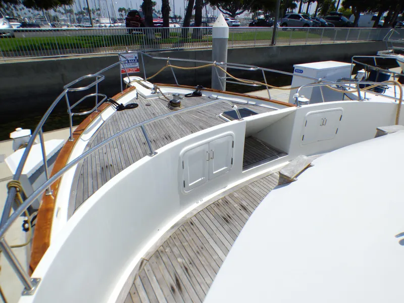 1987 MedYacht Mallorca 50 yacht deck with wooden flooring and railing, docked at marina.