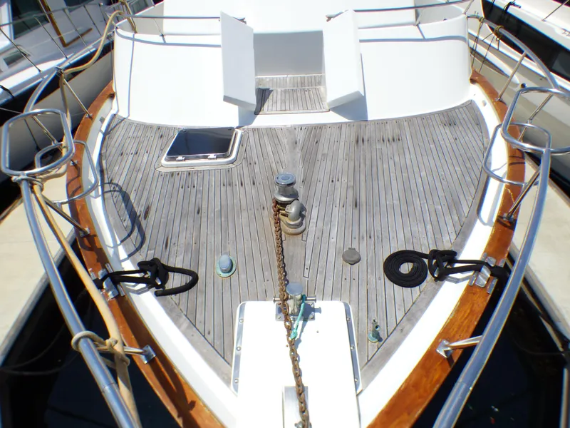 Deck of 1987 MedYacht Mallorca 50 with wooden finish and metal railings.