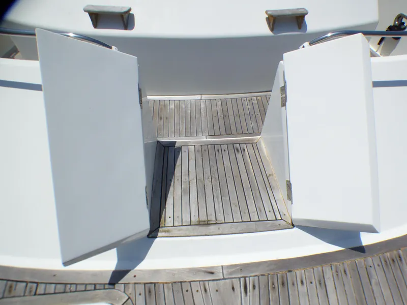 Open deck hatch on 1987 MedYacht Mallorca 50, featuring wooden flooring and white doors.