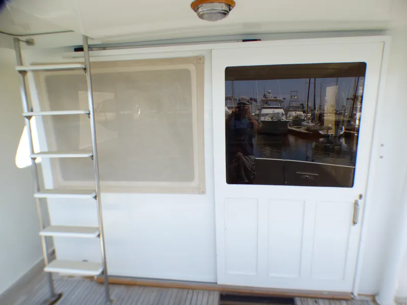 1987 MedYacht Mallorca 50 yacht deck with ladder and sliding door.