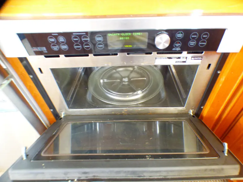 Built-in microwave oven on MedYacht Mallorca 50, 1987 model, with digital controls and open door.