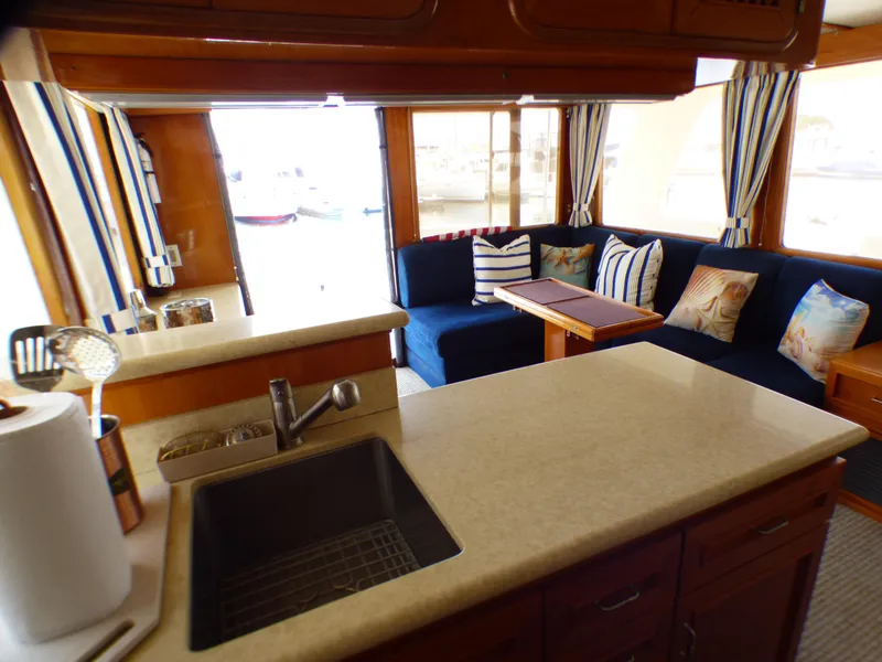 Interior of 1987 MedYacht Mallorca 50 with cozy seating and kitchenette.