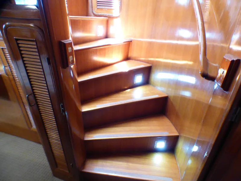 Wooden staircase with ambient lighting inside a 1987 MedYacht Mallorca 50.