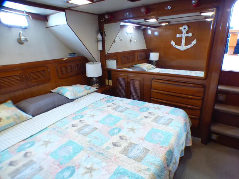 Luxurious 1987 MedYacht Mallorca 50 cabin with nautical decor and cozy bedding.