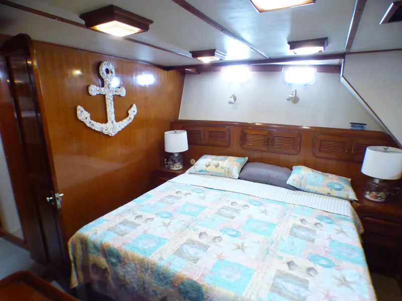 Luxurious cabin interior of 1987 MedYacht Mallorca 50 with nautical decor and cozy bedding.
