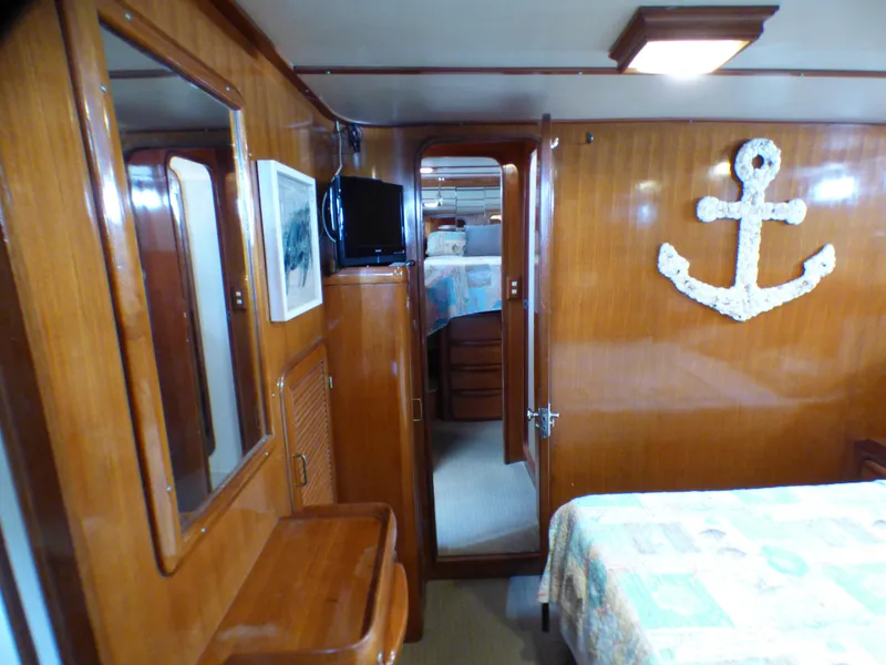 Interior of 1987 MedYacht Mallorca 50 with wooden paneling and nautical decor.