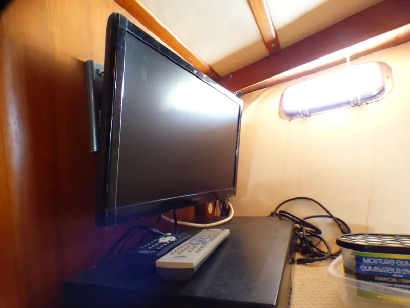 Flat-screen TV and remote in MedYacht Mallorca 50 cabin, 1987 model.