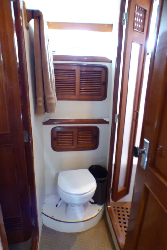 Bathroom interior of 1987 MedYacht Mallorca 50 with wooden accents and compact design.