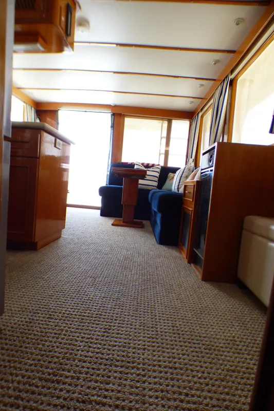 Interior of 1987 MedYacht Mallorca 50, featuring cozy seating and carpeted flooring.