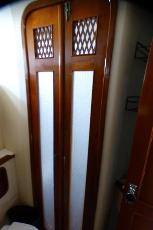 Wooden door with lattice design on a 1987 MedYacht Mallorca 50.