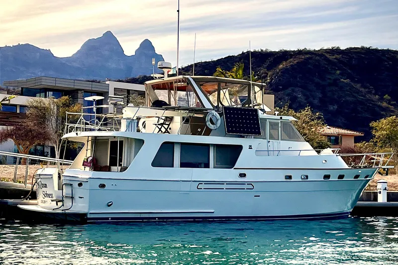 MedYacht Mallorca 50, 1987 model, docked with scenic mountain backdrop.