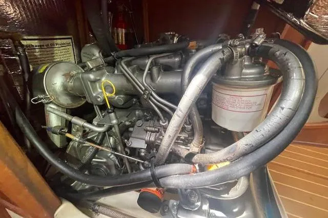 Engine compartment of a 2001 Hunter 380 sailboat, showcasing intricate mechanical components.