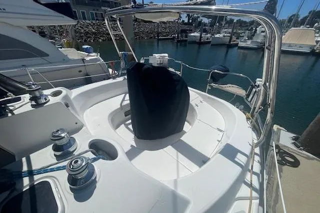 Sailboat cockpit of 2001 Hunter 380, docked in a marina with surrounding boats.