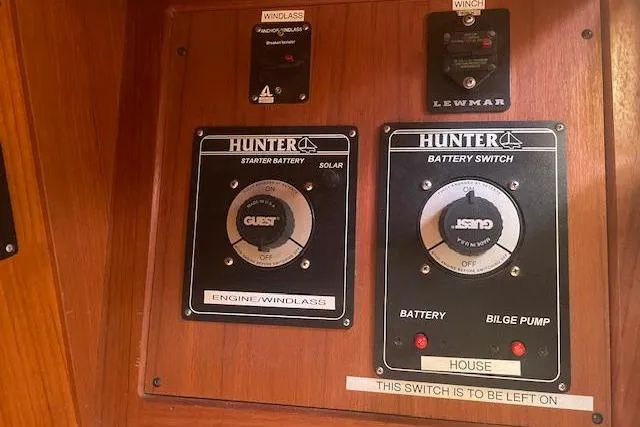 Control panel of a 2001 Hunter 380 sailboat with battery switches and windlass controls.