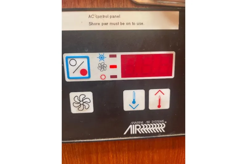 Control panel of a 2001 Hunter 380 boat, displaying temperature and fan settings.
