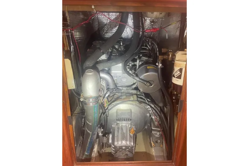 Engine compartment of a 2001 Hunter 380 sailboat, showcasing mechanical components and wiring.