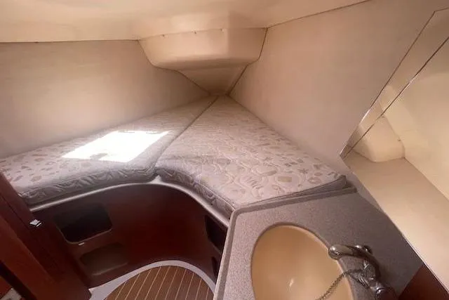 Interior cabin of 2001 Hunter 380 sailboat with bed and sink.