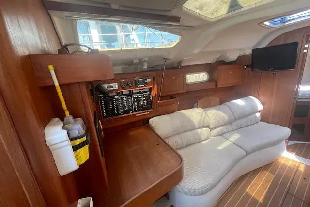 Interior of 2001 Hunter 380 yacht with wooden finish and cozy seating area.