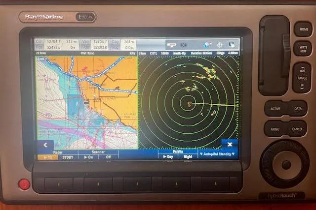 Raymarine navigation system displaying nautical chart and radar on a Hunter 380, 2001 model.