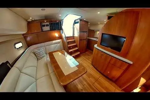 Luxurious interior of 2006 Tiara Yachts 4300 Sovran with elegant wood finishes and plush seating.