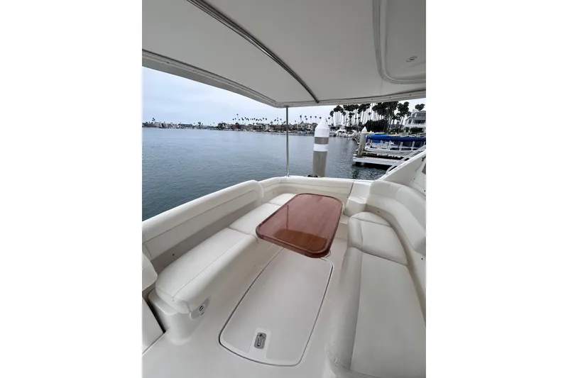 2006 Tiara Yachts 4300 Sovran cockpit with seating and table, overlooking marina.