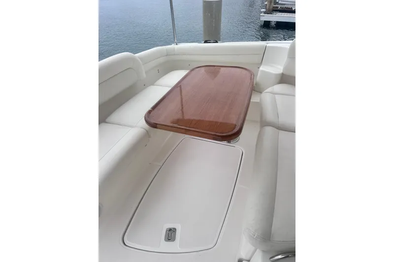Luxurious seating area on 2006 Tiara Yachts 4300 Sovran with wooden table.