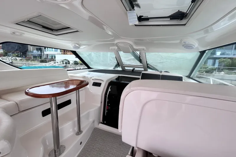Interior of 2006 Tiara Yachts 4300 Sovran with sleek seating and wooden table.