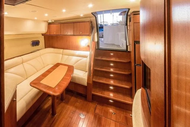 2007 Tiara Yachts 4300 Sovran interior with elegant wood finish and cozy seating area.