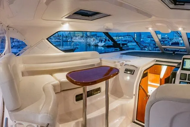 Interior of 2007 Tiara Yachts 4300 Sovran, featuring elegant seating and a polished table.