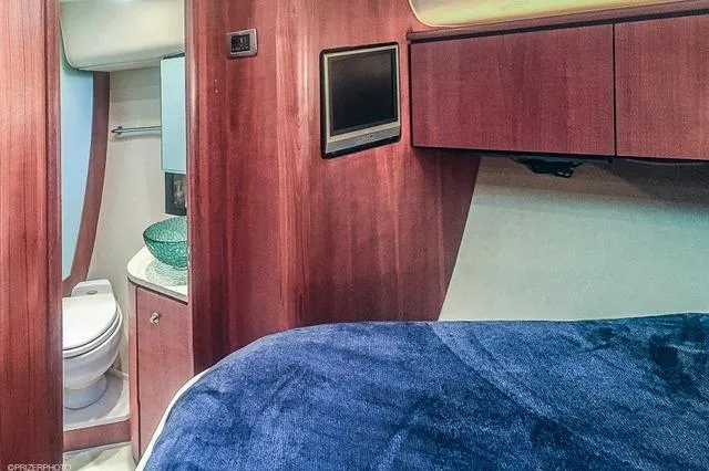 2007 Tiara Yachts 4300 Sovran interior with bed, TV, and bathroom.