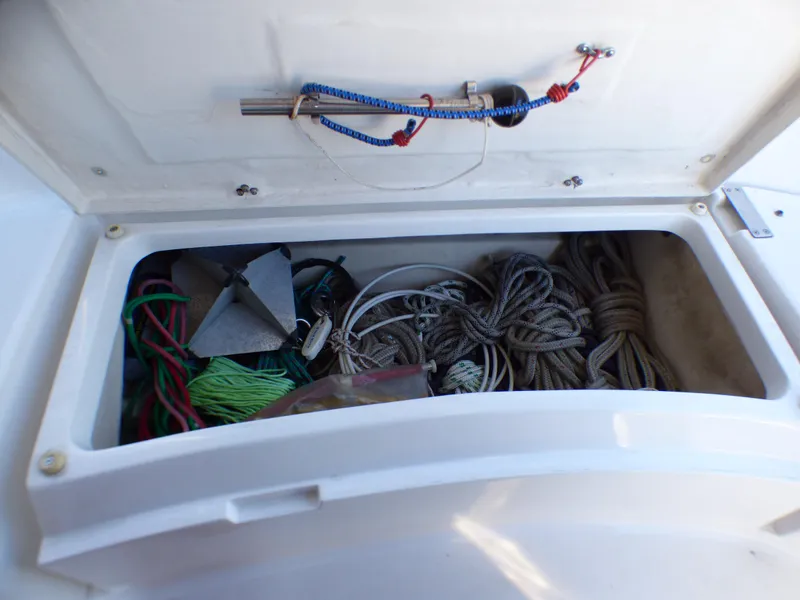 Storage compartment of a 1998 Hunter 34 sailboat with ropes and anchor.