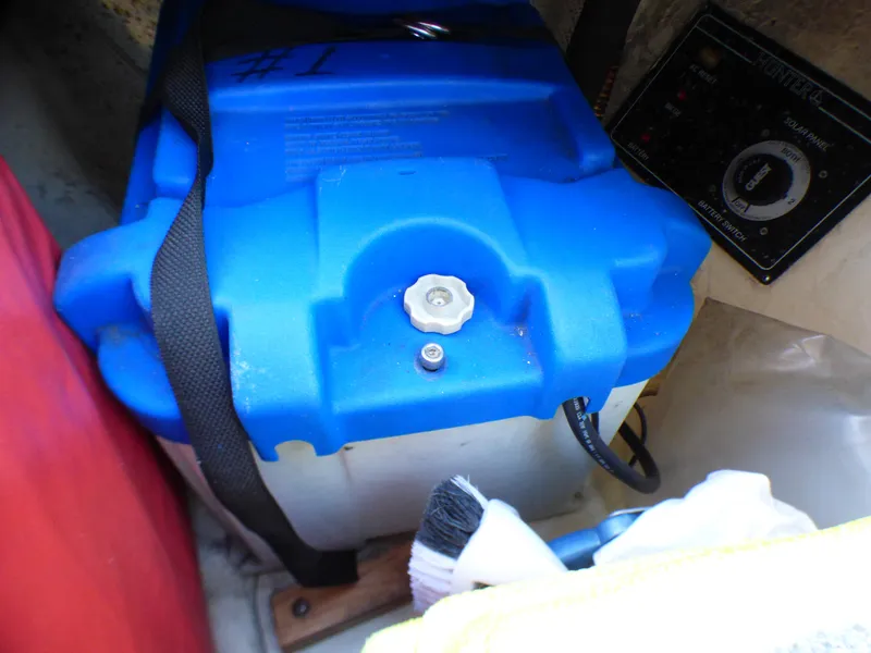 Battery in a 1998 Hunter 34 boat, blue casing, secured with strap.