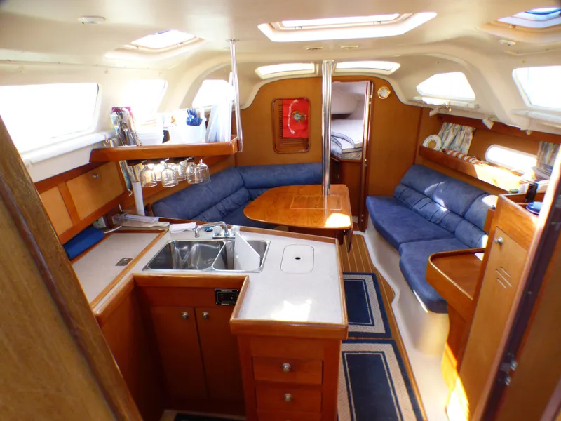Interior of a 1998 Hunter 34 yacht with kitchen and seating area.