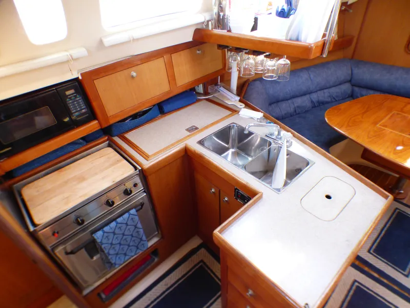 Interior of a 1998 Hunter 34 yacht with kitchen and seating area.