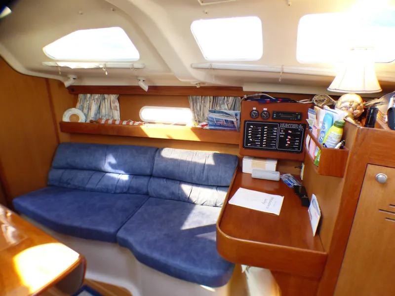 Interior of a 1998 Hunter 34 yacht with blue upholstery.