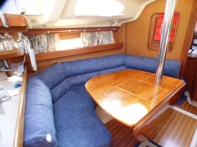 Interior of a 1998 Hunter 34 yacht with blue upholstery.