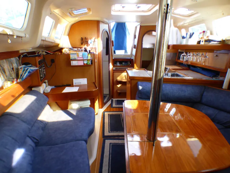 Interior of a 1998 Hunter 34 yacht with cozy furnishings.