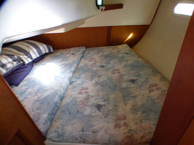 Interior of a 1998 Hunter 34 yacht featuring a cozy sleeping area.