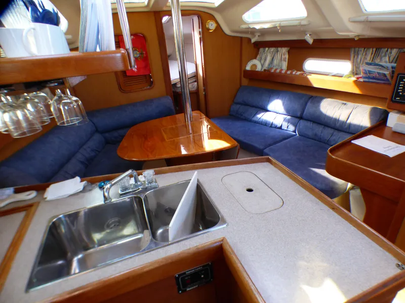 Interior of a 1998 Hunter 34 yacht with kitchen and seating area.